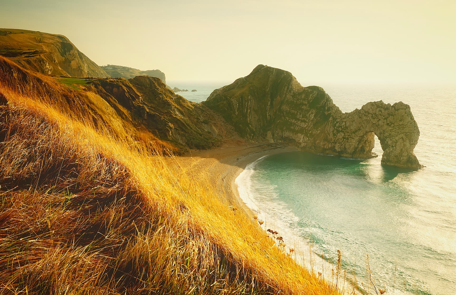 Durdle Door natural limestone arch on Dorset Jurassic Coast at golden hour